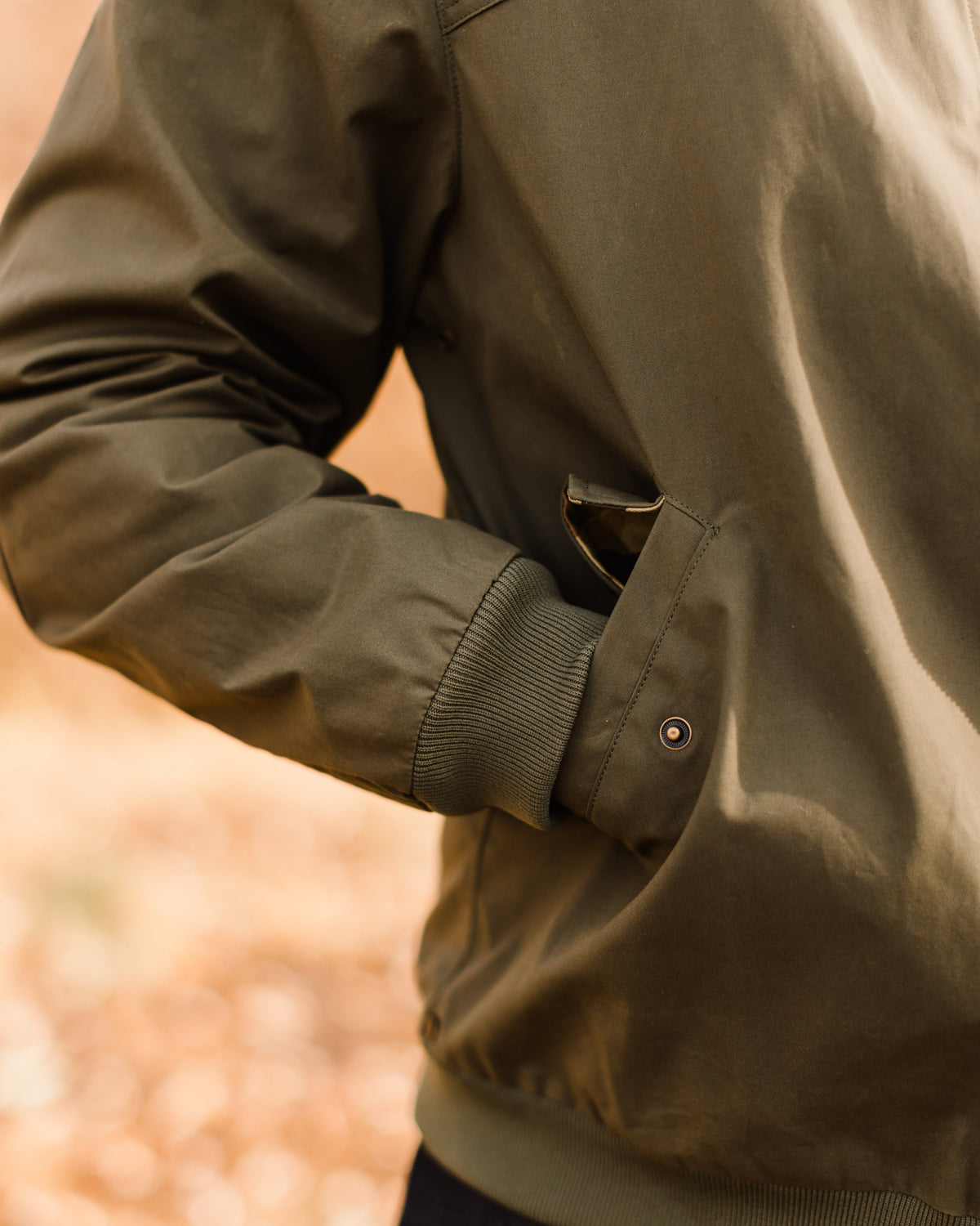 Hand warmer pocket on the Sage Green Harrington Jacket, worn