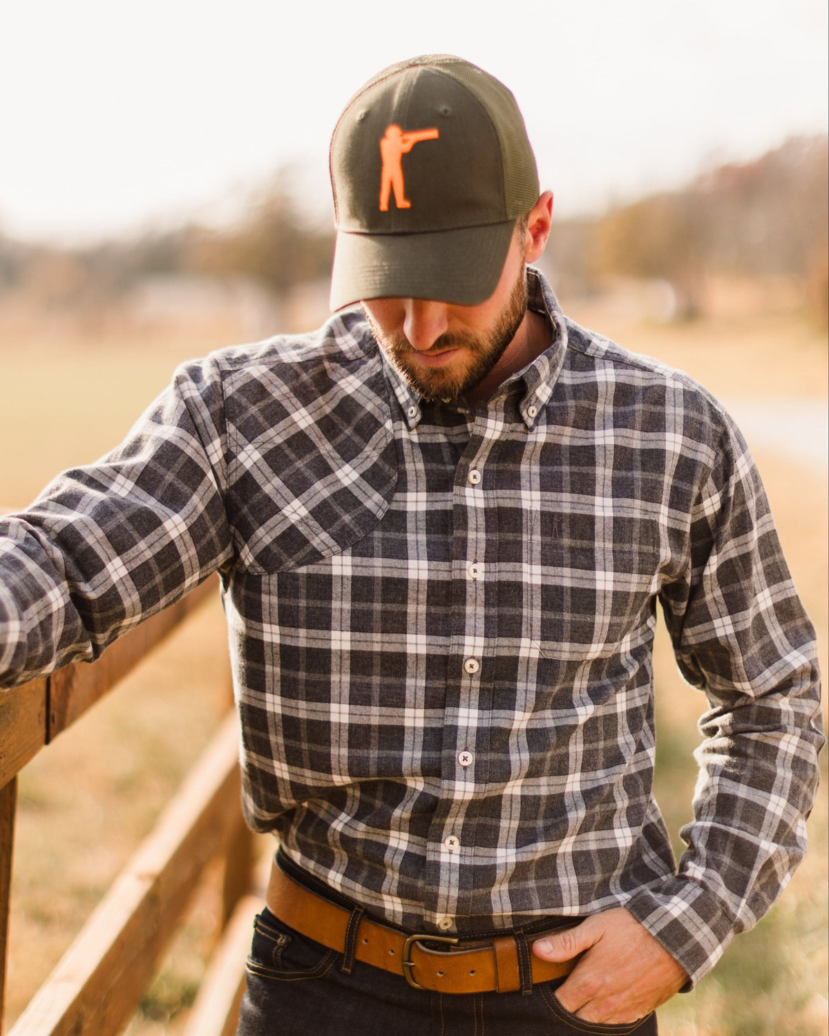 Close view of a man wearing the Olive Arthur Core Snapback with a plaid shirt