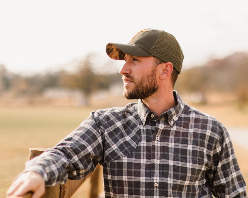 Arthur Core Snapback worn at a fence line, profile view