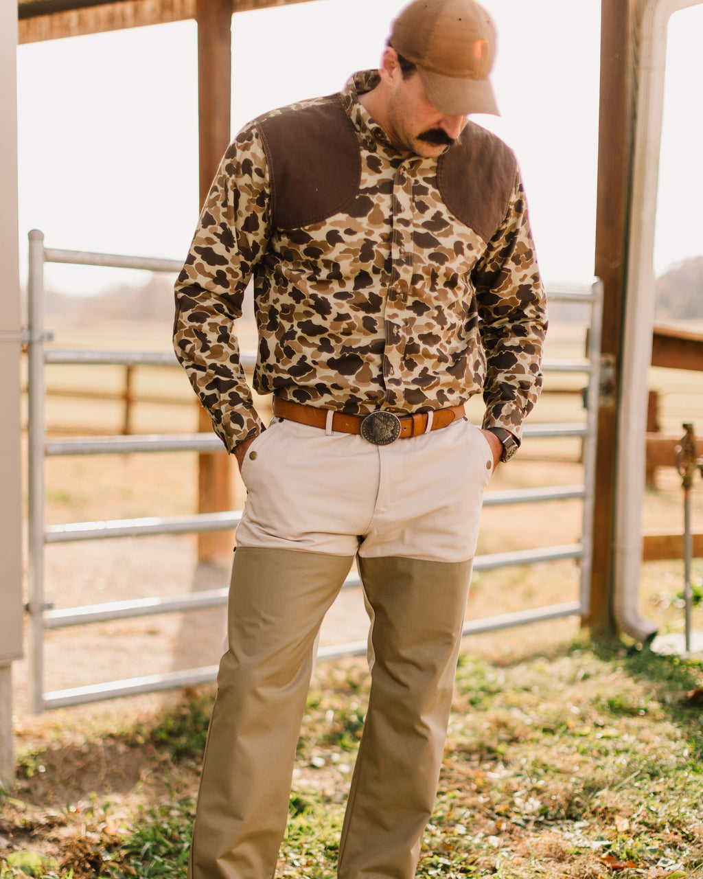 Original Camo Sportsmans Shirt FG worn tucked in, looking down at a fence gate