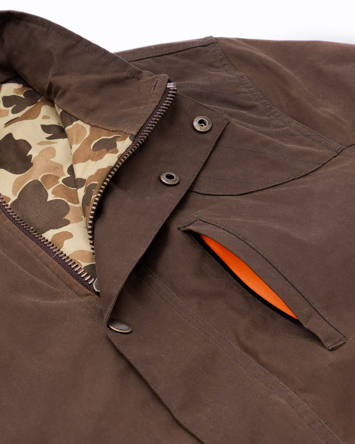 Collar and blaze orange lined hand warmer pocket on the Oak Waxed Field Jacket