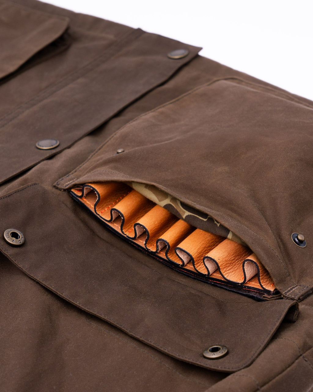 Self-draining shell pocket holding shotgun shells on the Oak Waxed Field Jacket