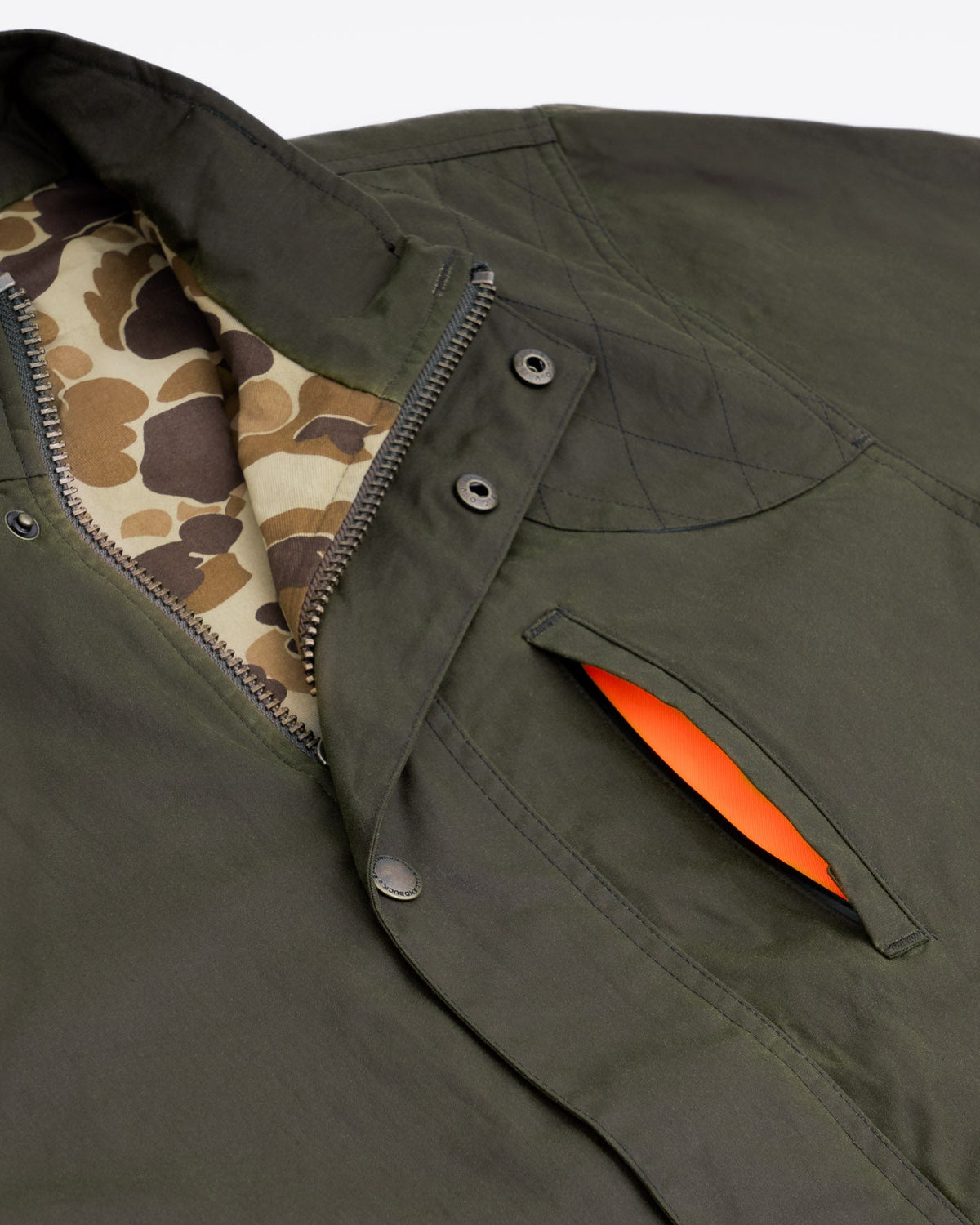 Collar and blaze orange lined pocket detail on the Dark Olive Waxed Field Jacket
