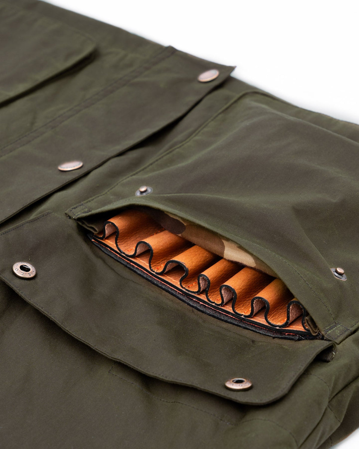 Shell pocket loaded with shotgun shells on the Dark Olive Waxed Field Jacket