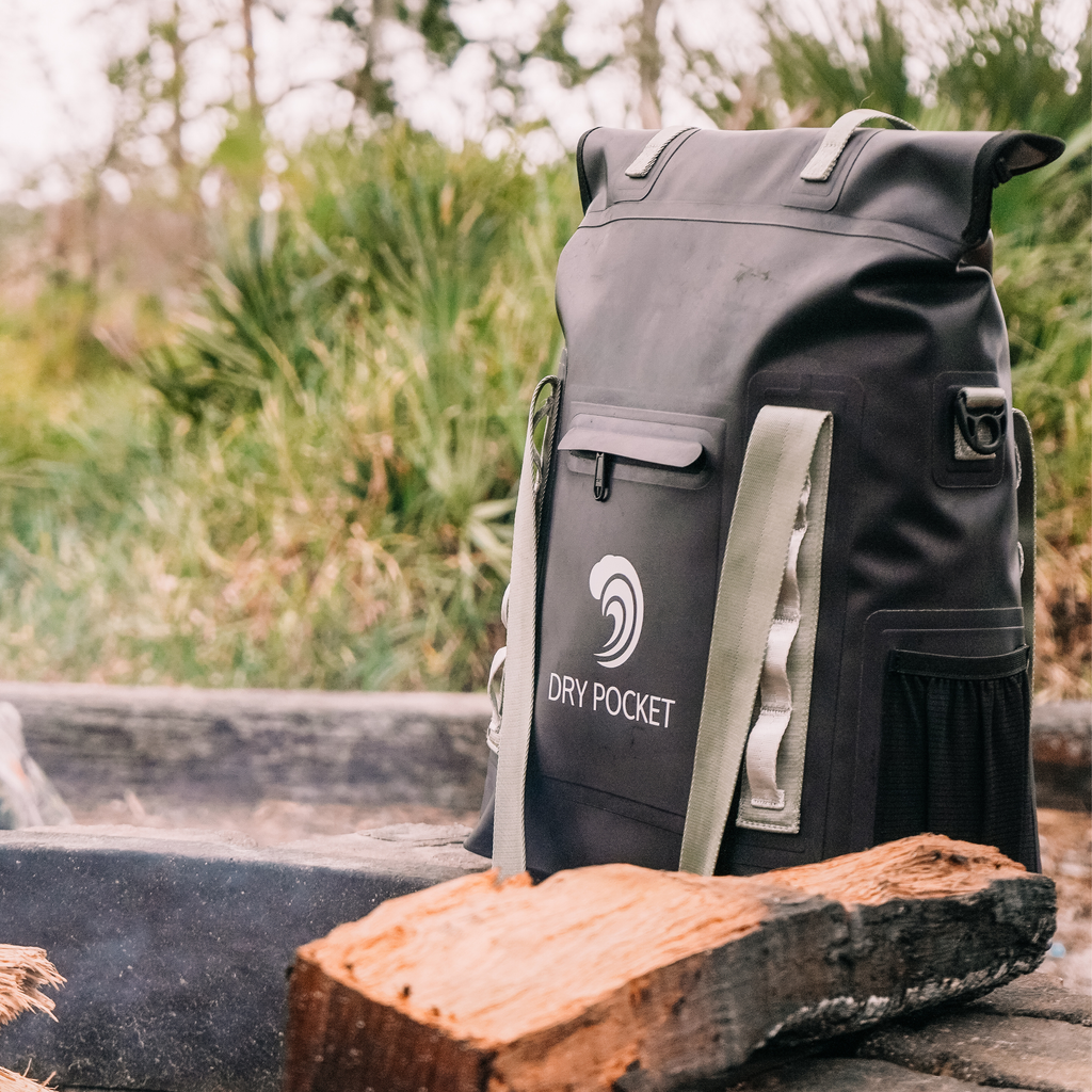Black waterproof dry pocket backpack with olive straps, ideal for hunting and outdoor adventures