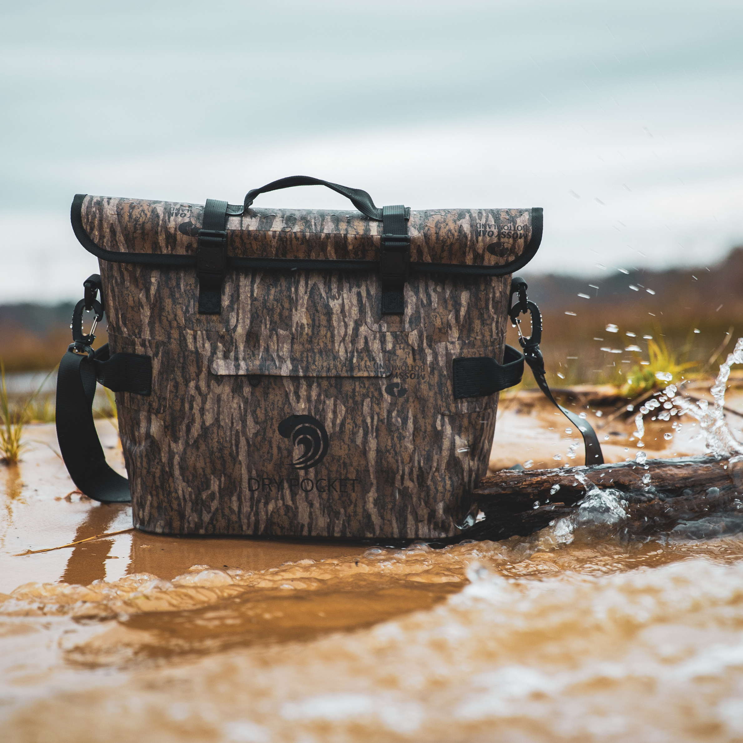 Mossy Oak Bottomland camo dry bag for hunting, waterproof gear storage in wet outdoor conditions