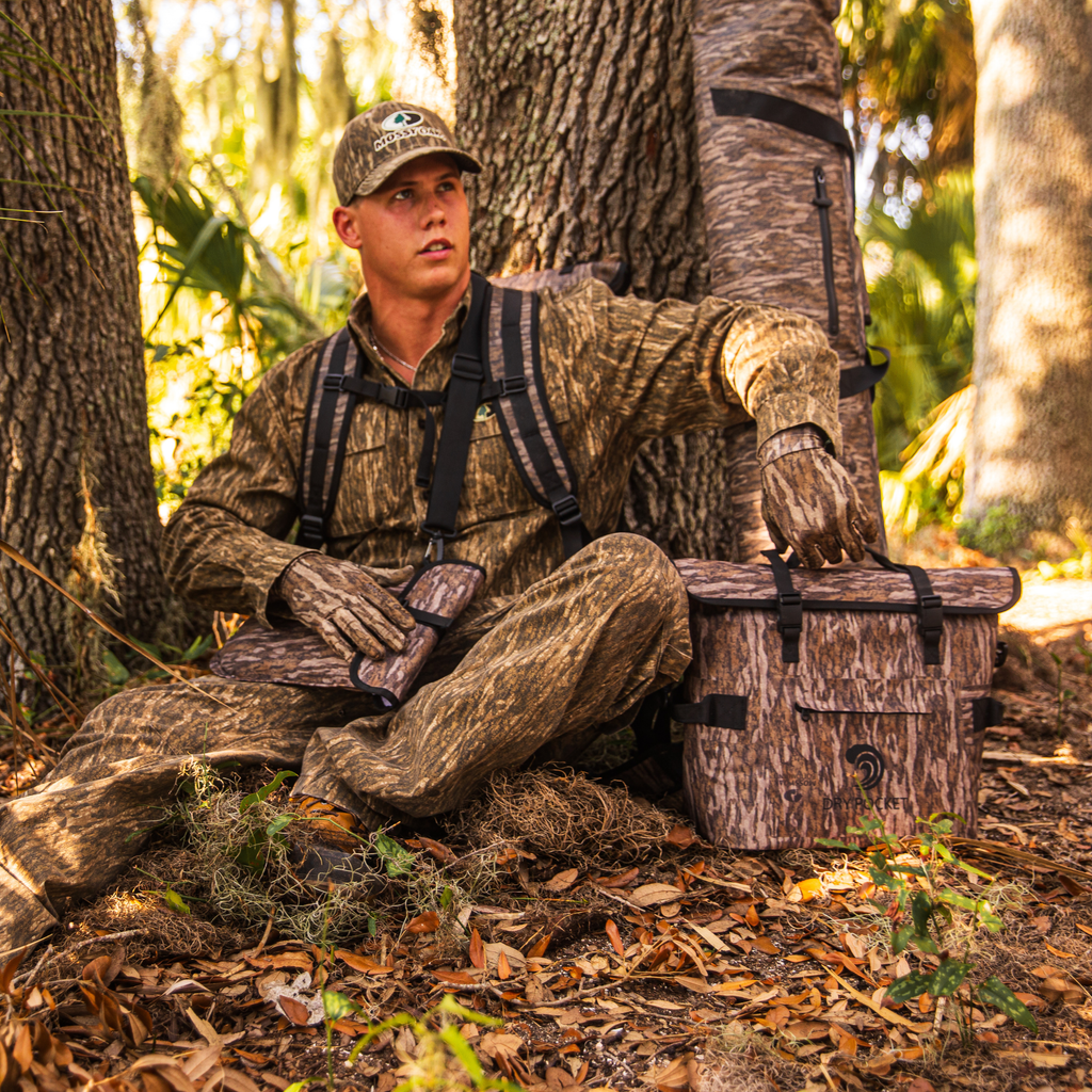 Mossy Oak camo hunting gear with dry pocket cooler, gloves, and hat for outdoor hunting adventures