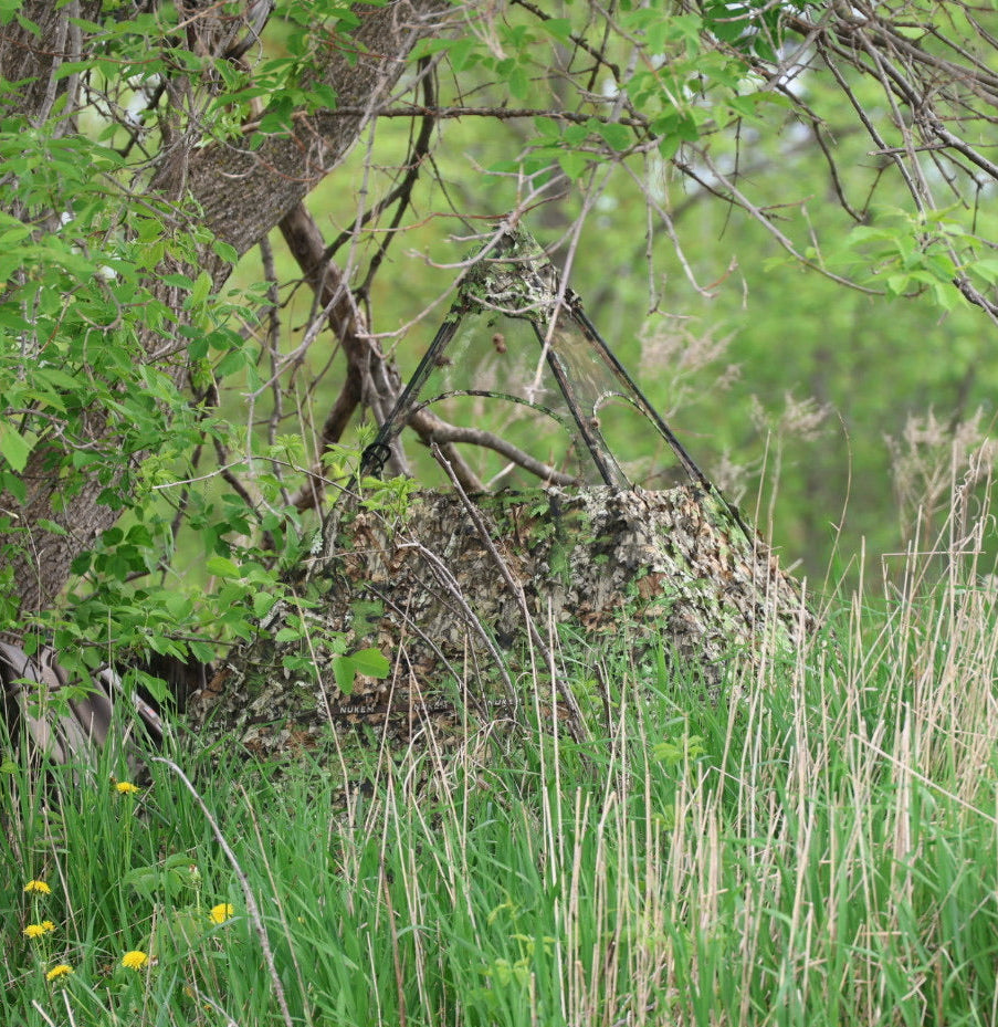 Camo hunting blind with mesh window, blending into forest foliage for concealment during deer or turkey hunts