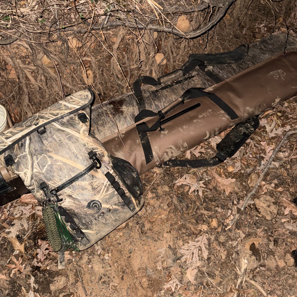 Camo hunting backpack with dry pocket and rifle case on forest floor, ideal for outdoor gear and hunting trips