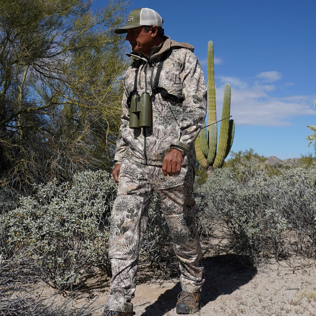 Desert camo hunting suit with binoculars, ideal for arid terrain and outdoor adventures