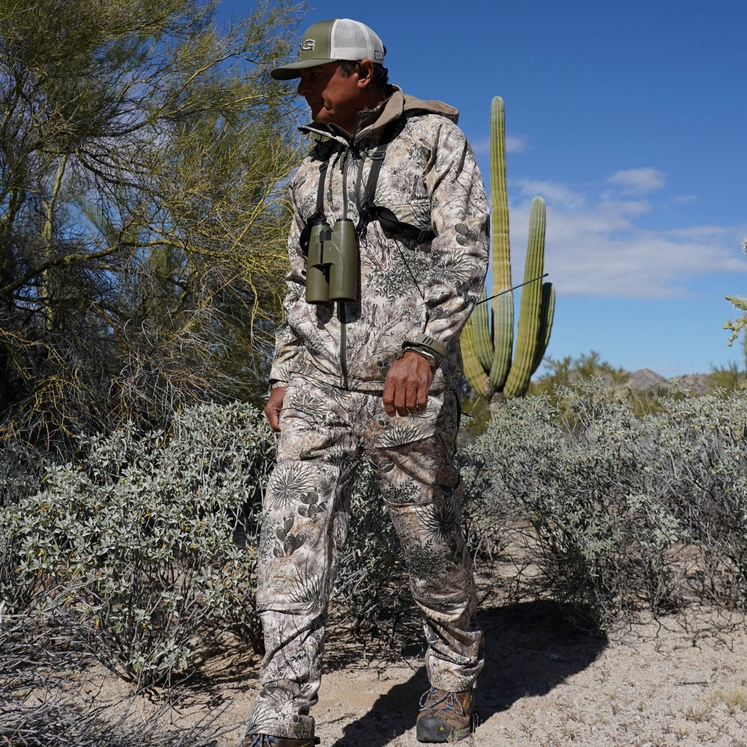 Desert camo hunting suit with binoculars, ideal for arid terrain and outdoor adventures