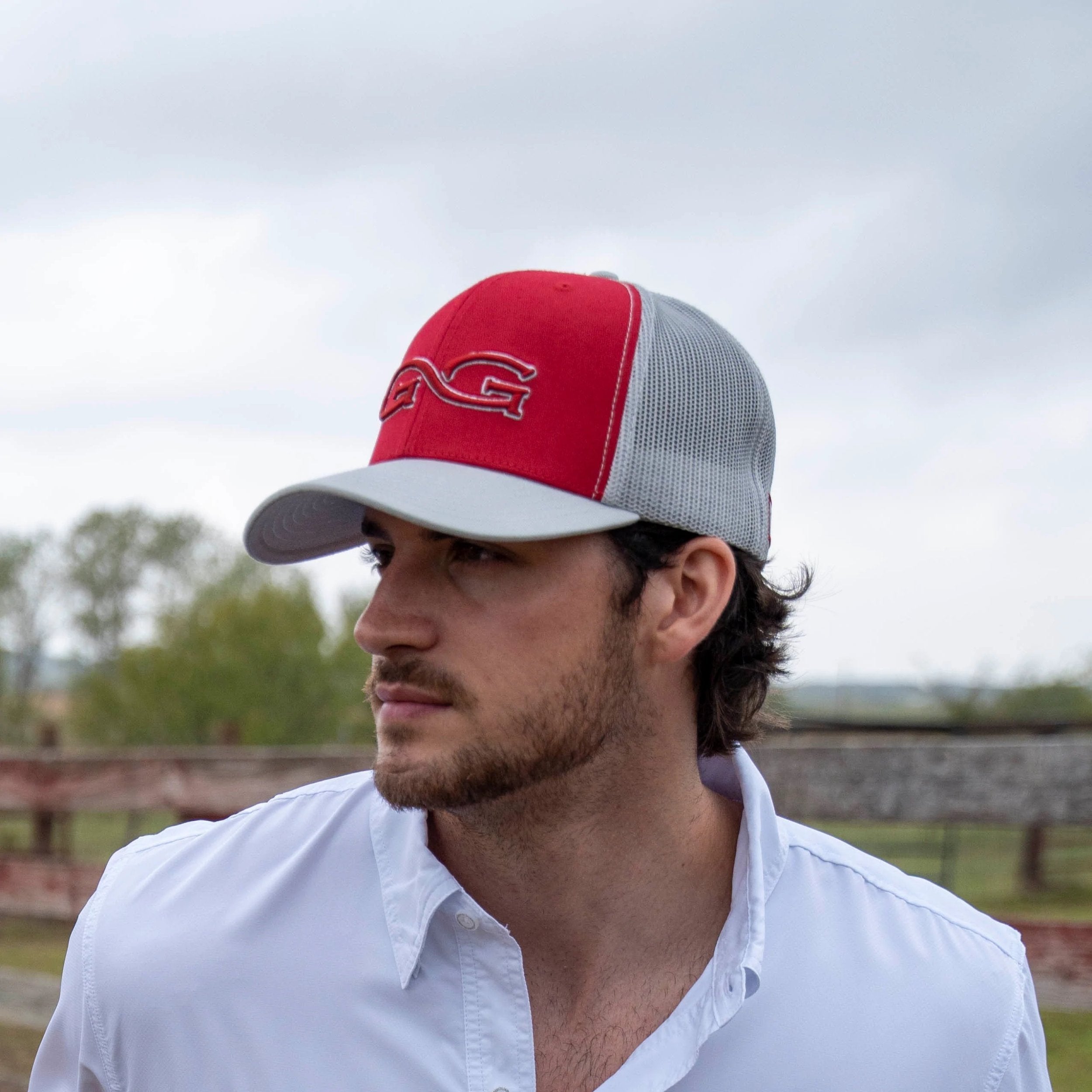 Red and gray trucker hat with embroidered logo, outdoor hunting apparel