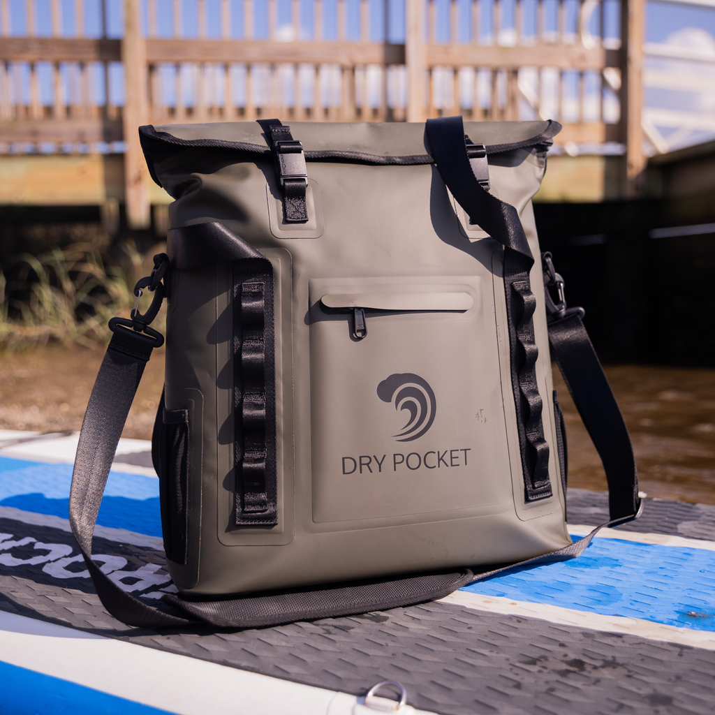 Gray Dry Pocket waterproof dry bag with black straps, ideal for fishing and outdoor adventures on watercraft.