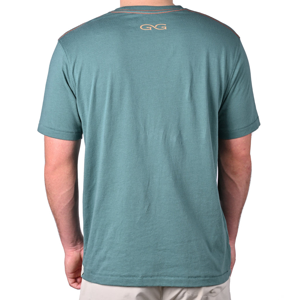 Green outdoor t-shirt with orange stitching and GG logo, ideal for hunting and fishing adventures
