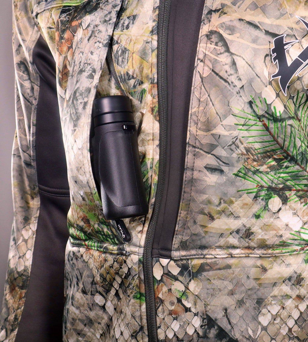 Close-up of a Vycah Kinsley Jacket chest pocket holding a hunting tool, showing the Vycah logo