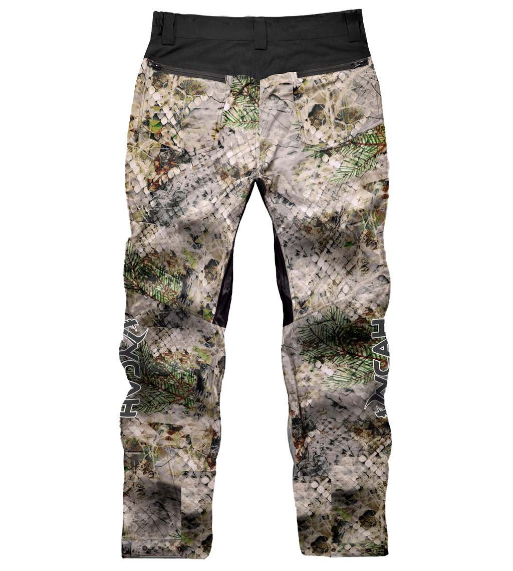 Camo hunting pants with pine needle pattern, black waistband, and reinforced knees for outdoor use