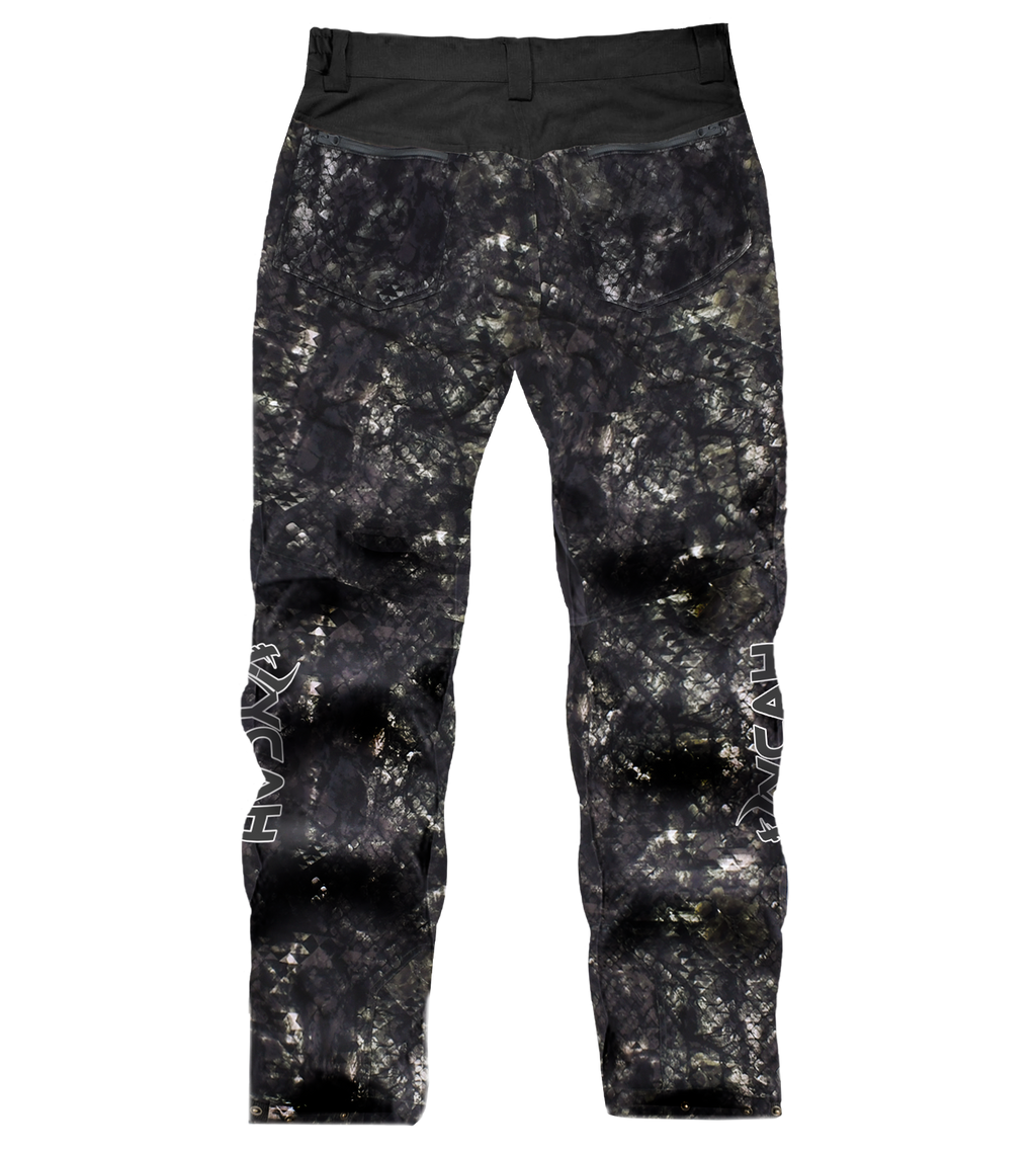 Black and gray camo hunting pants with rear pockets and side logos, designed for outdoor stealth and durability.