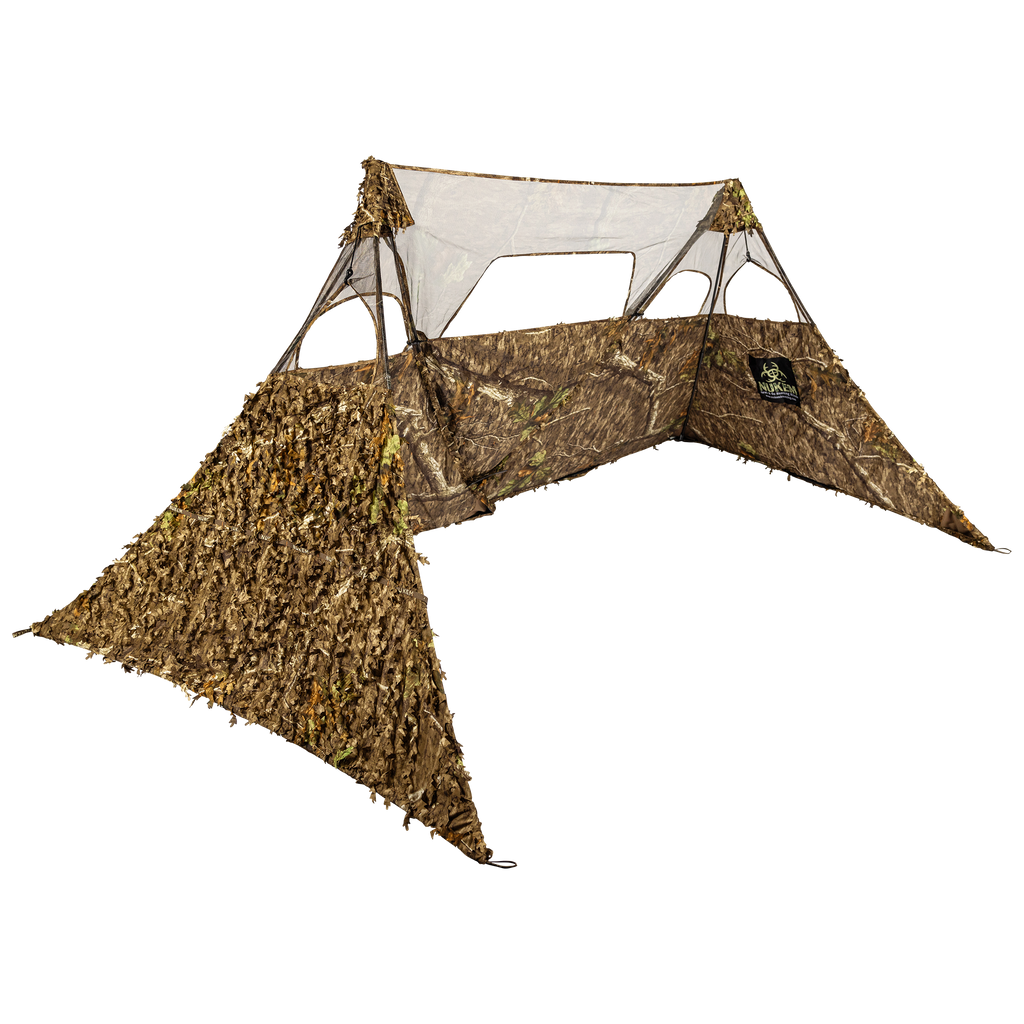 Camouflage hunting blind with leafy 3D pattern and mesh windows for concealment in woods