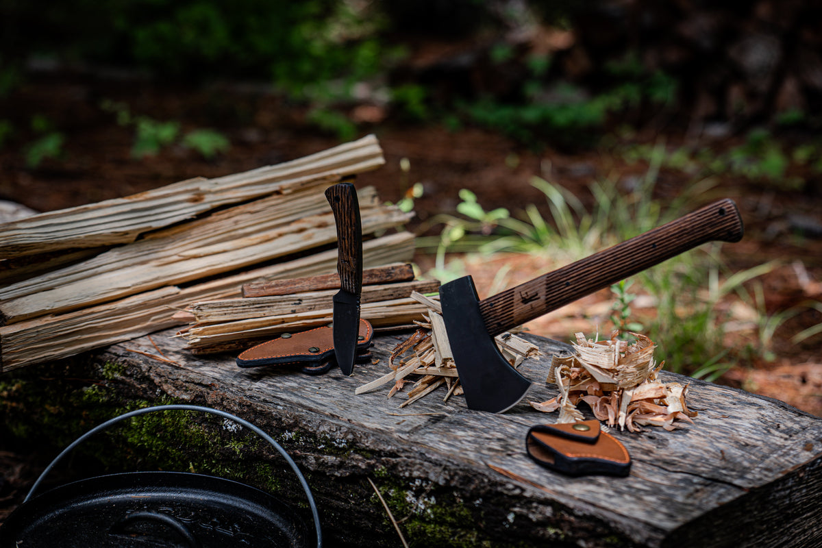 Highland Hatchet and leather sheath on a log in the woods