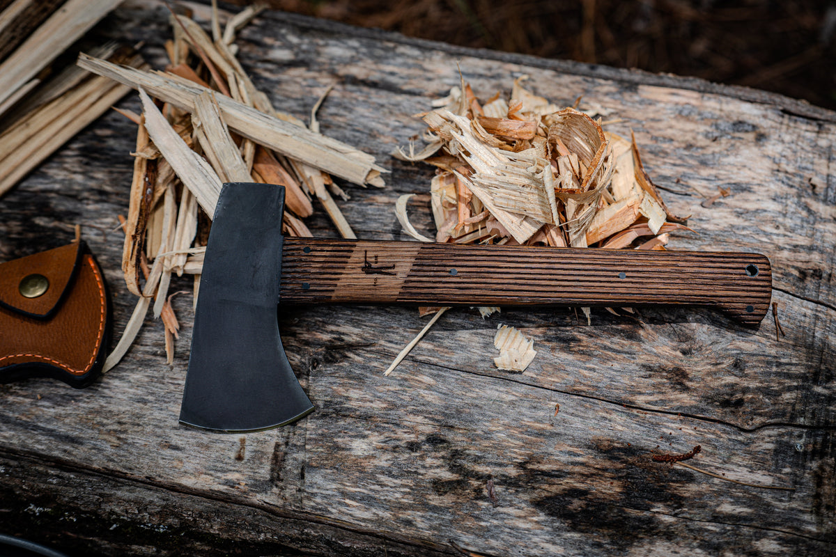 Winkler x Ball and Buck Highland Hatchet on a split log among wood shavings