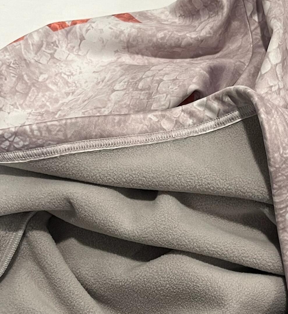 Soft fleece hunting blanket with muted camo pattern, ideal for outdoor gear and cold weather comfort.