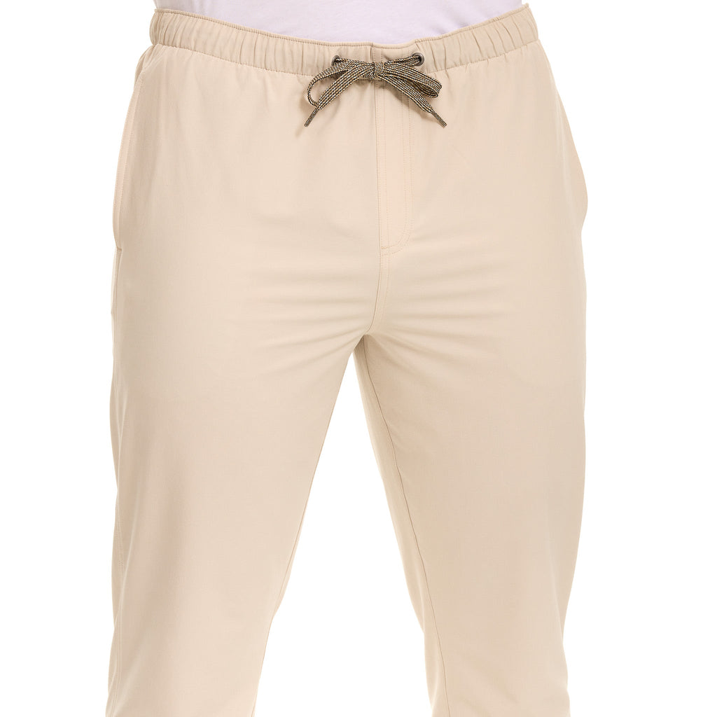 Tan drawstring hunting pants with elastic waist, ideal for outdoor adventures and field use