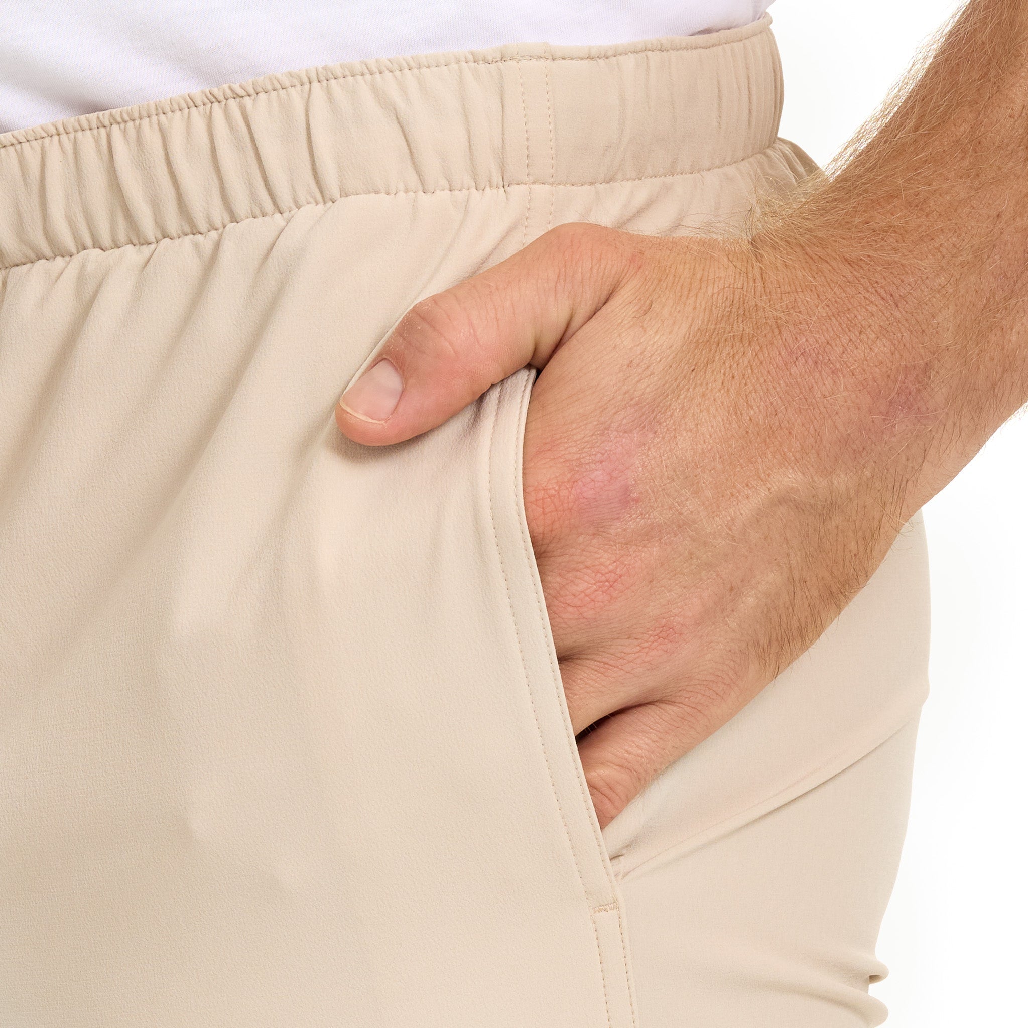 Tan hunting pants with elastic waistband and side pocket, ideal for outdoor adventures and field use.