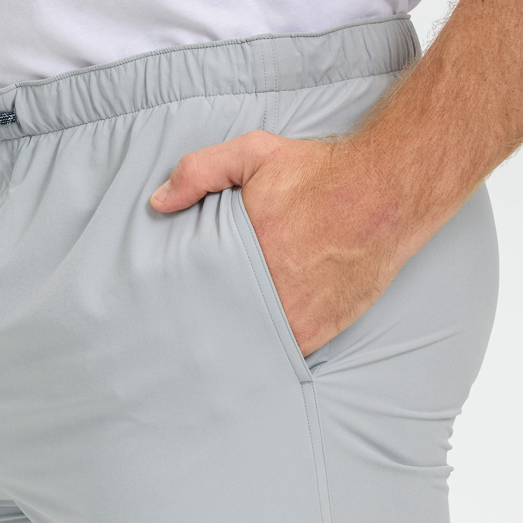 Light gray men's outdoor pants with elastic waistband and side pocket, ideal for hunting and hiking