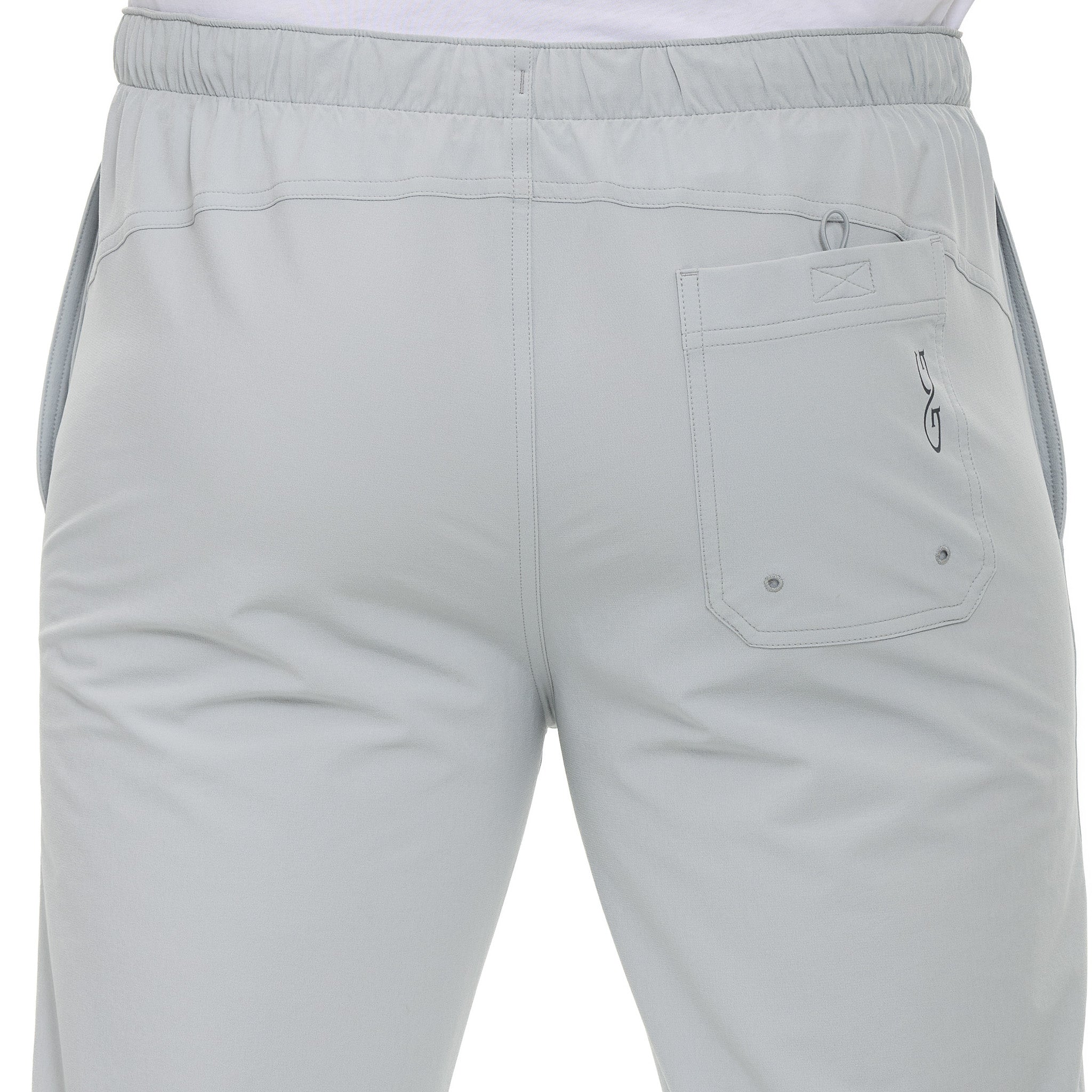 Light gray hunting pants with elastic waist, rear pocket, and logo detail for outdoor use