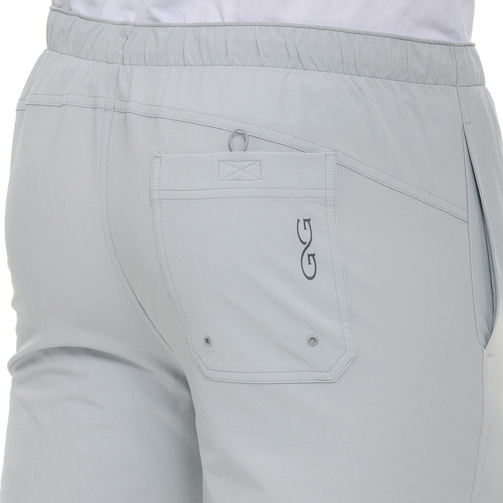 Light gray outdoor pants with elastic waist, back pocket, and logo detail for hiking or hunting