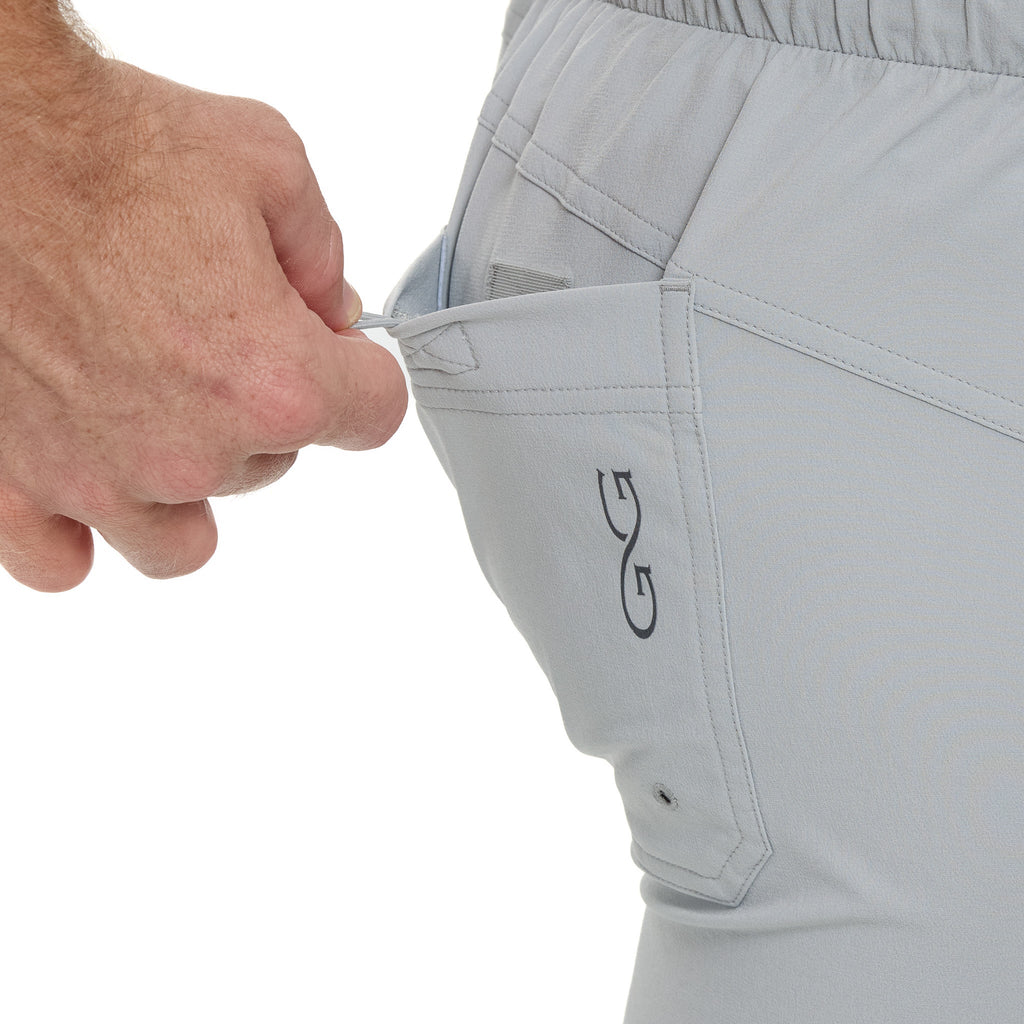 Light gray hunting pants with zippered pocket and drawstring waist, ideal for outdoor adventures