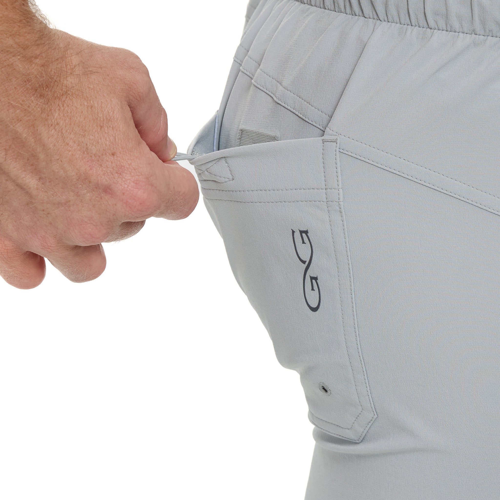 Light gray hunting pants with zippered pocket and drawstring waist, ideal for outdoor adventures