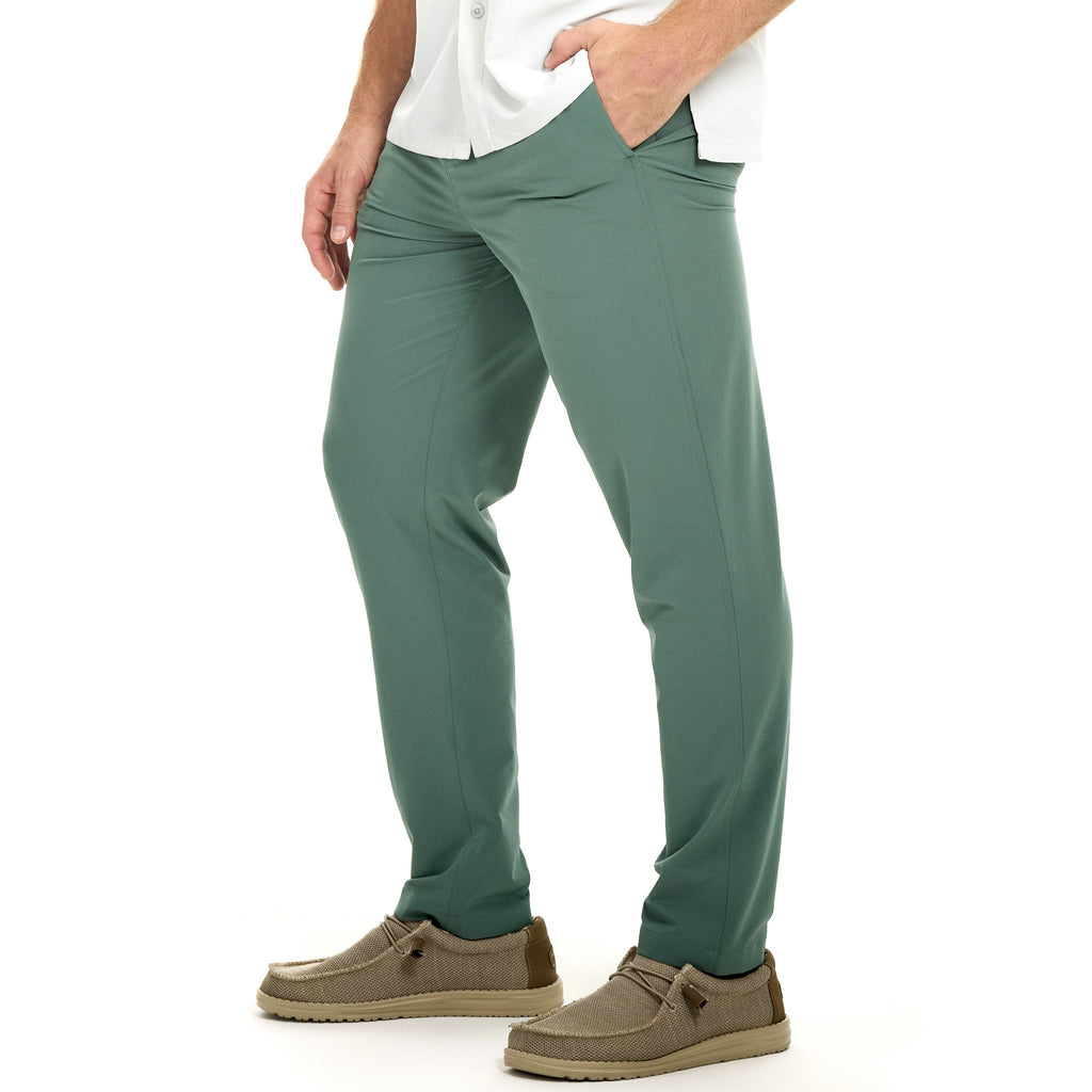 Men's olive green outdoor hunting pants with stretch fabric, side pockets, paired with casual boat shoes