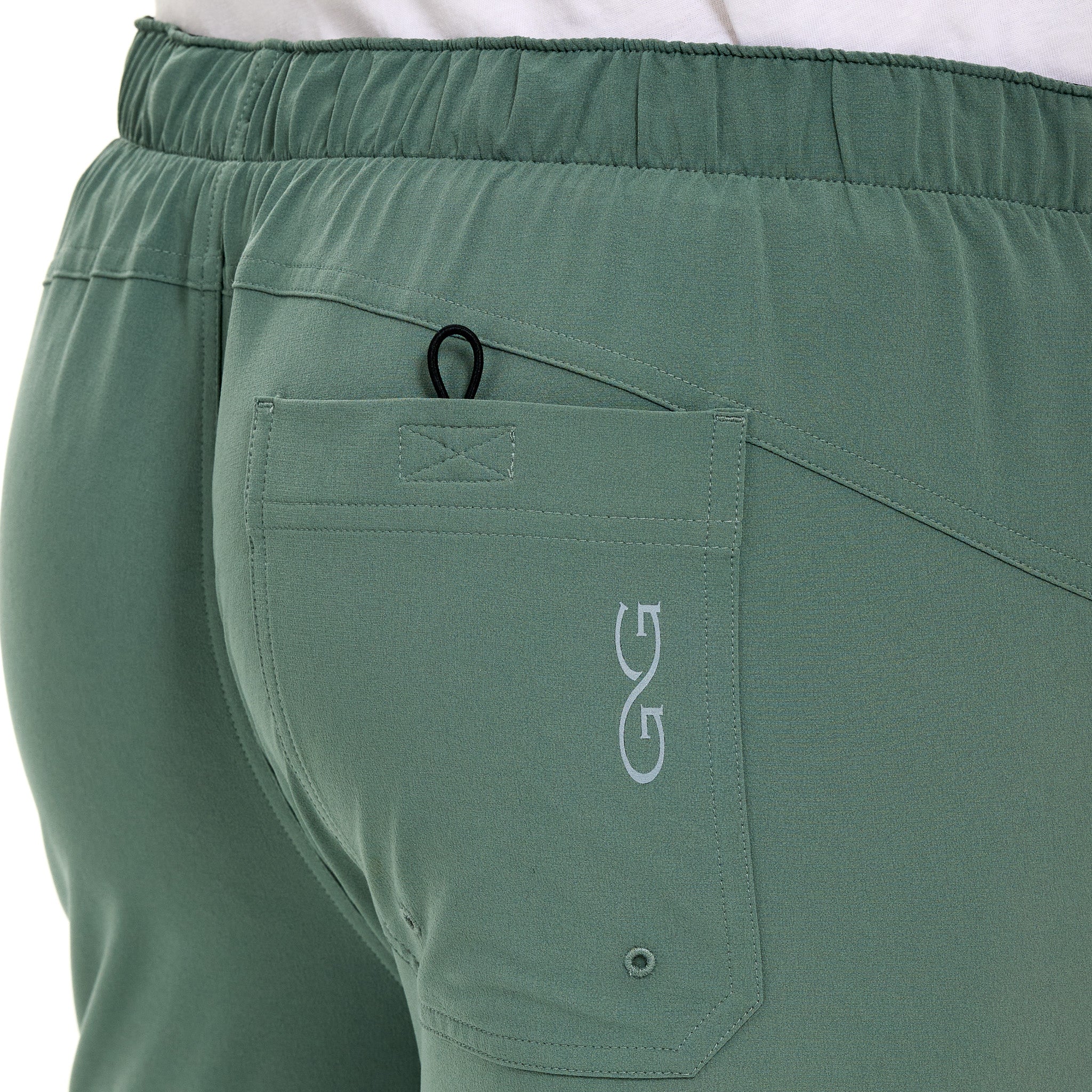 Olive green hunting pants with elastic waist, rear pocket, and gear loop for outdoor adventures