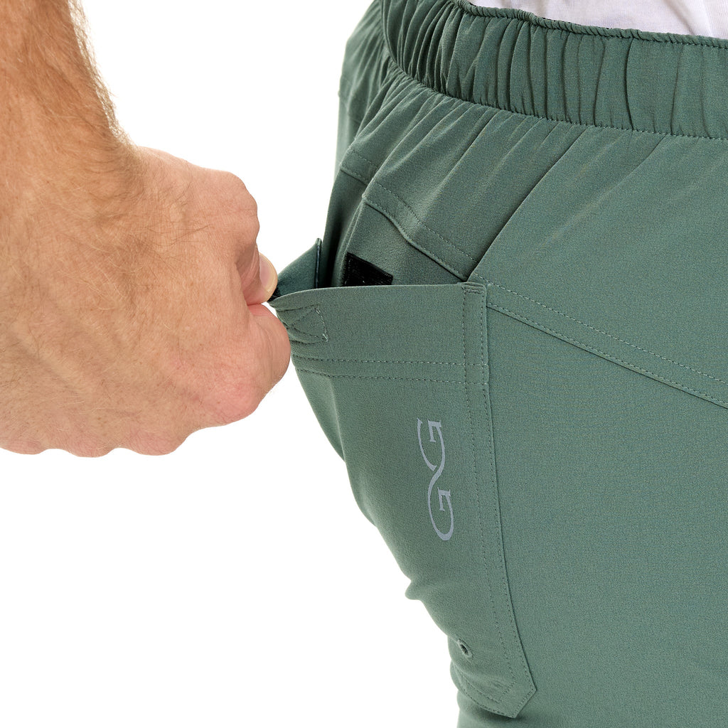 Olive green hunting pants with secure zip pocket and elastic waistband for outdoor adventures