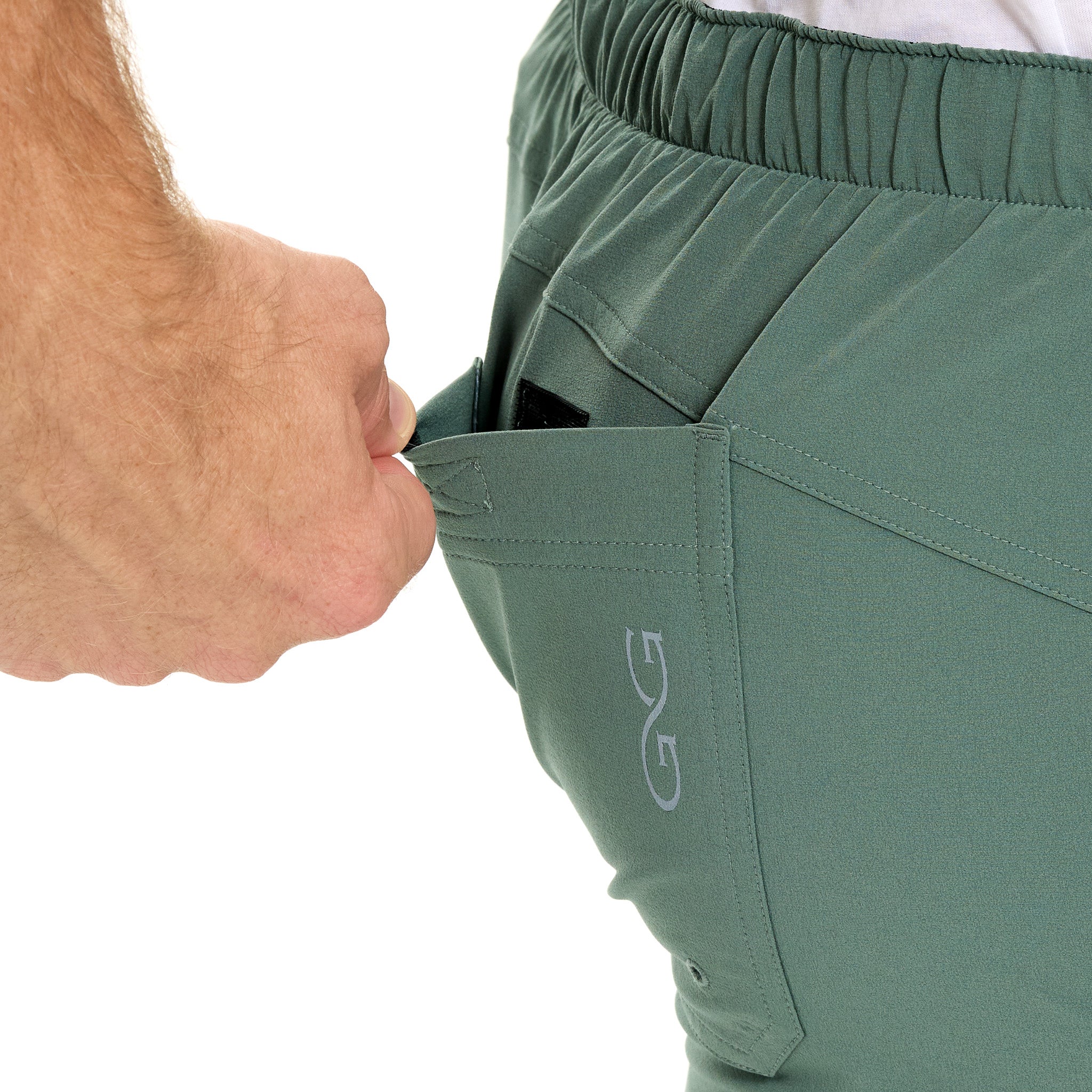 Olive green hunting pants with secure zip pocket and elastic waistband for outdoor adventures
