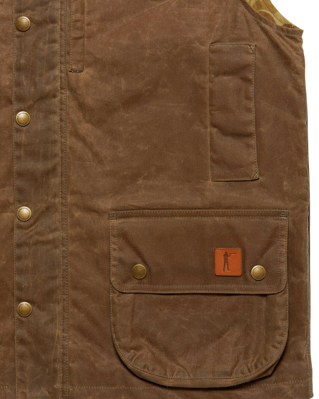 Front flap pocket with leather Arthur patch and zippered map pocket on the Dark Oak Upland Vest