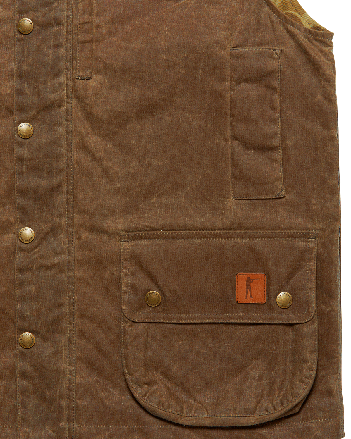 Front flap pocket with leather Arthur patch and zippered map pocket on the Dark Oak Upland Vest