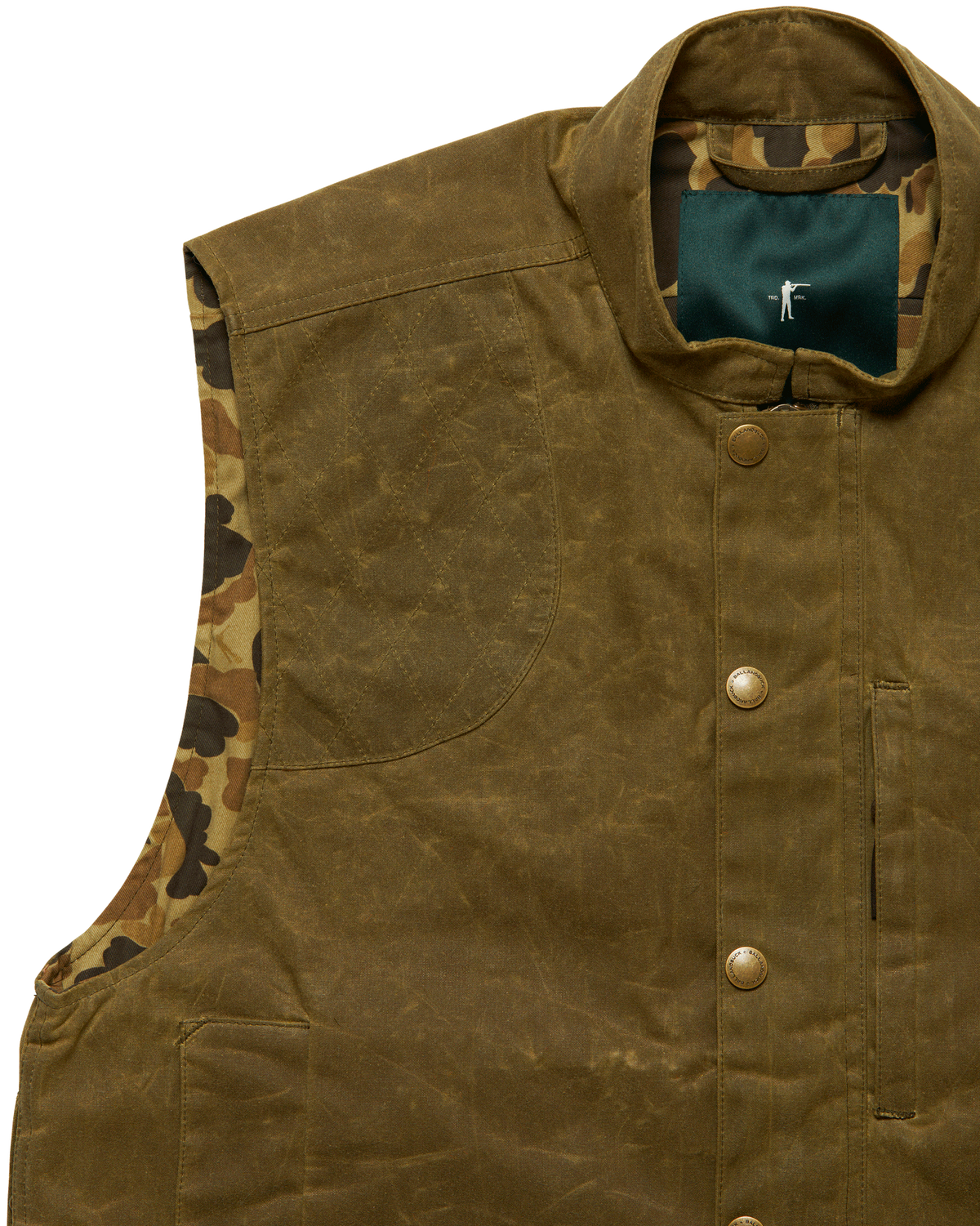 Shoulder and armhole detail on the Olive Upland Vest showing camo lining
