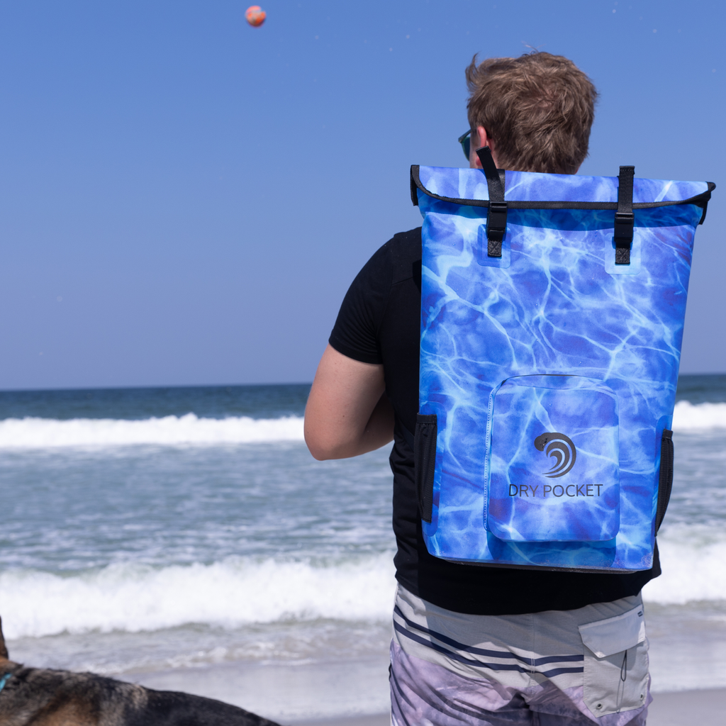 Blue water-pattern dry bag backpack with roll-top closure, ideal for beach, fishing, or outdoor adventures