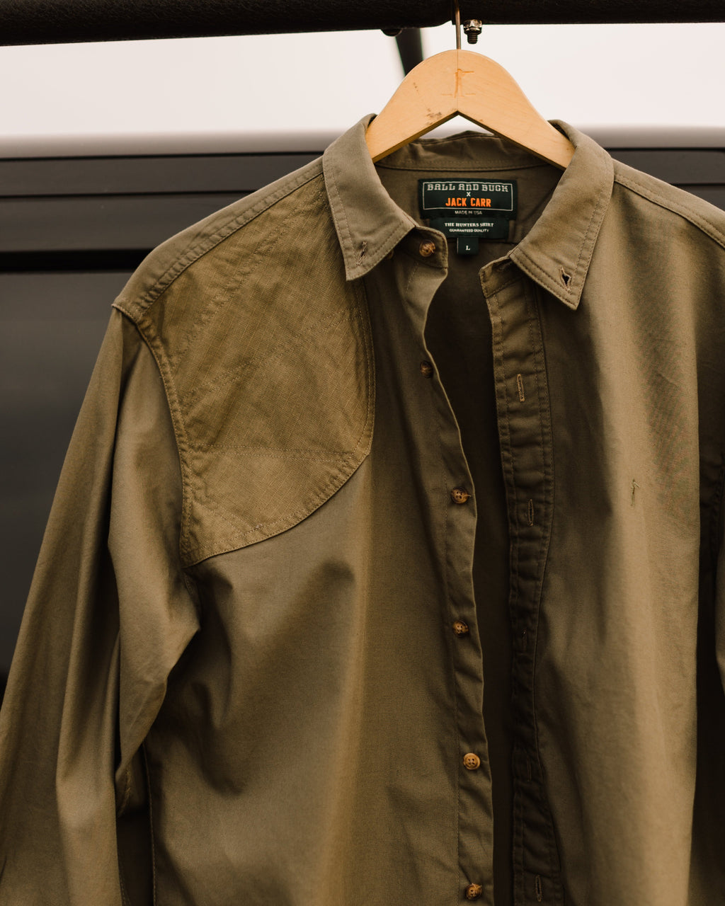 Ranger Green Jack Carr Hunters Shirt hanging on a hanger