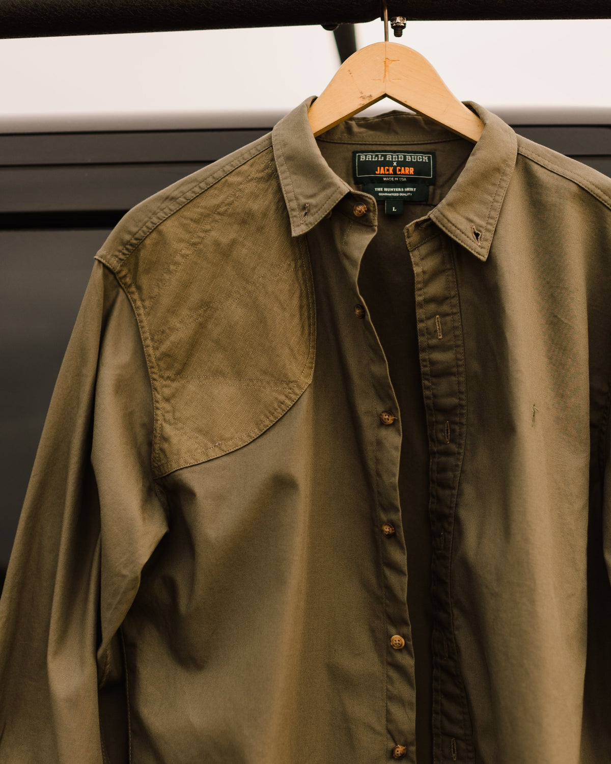 Ranger Green Jack Carr Hunters Shirt hanging on a hanger