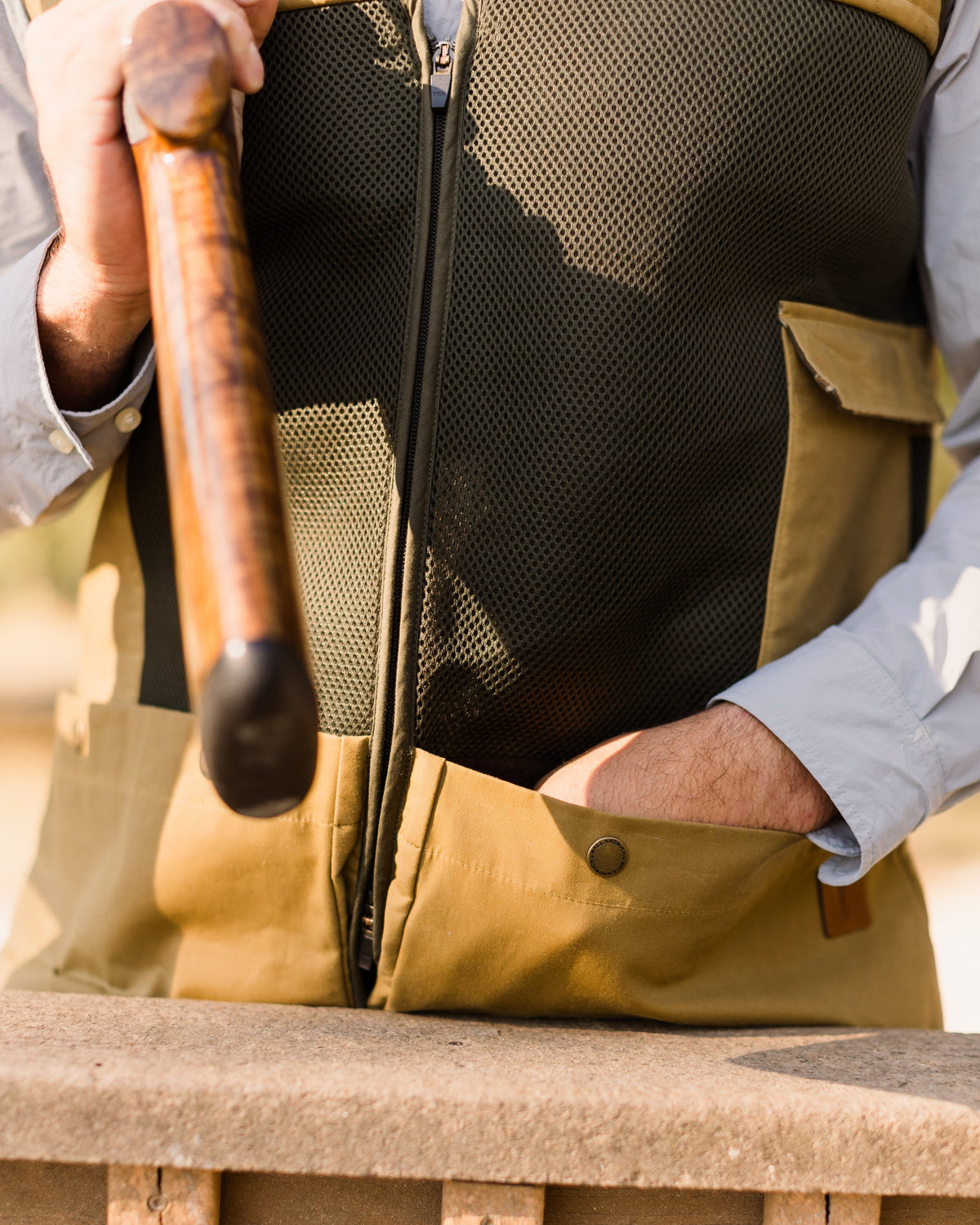Easy-empty zipper being opened at the bottom of a Heritage Clays Vest shell pocket