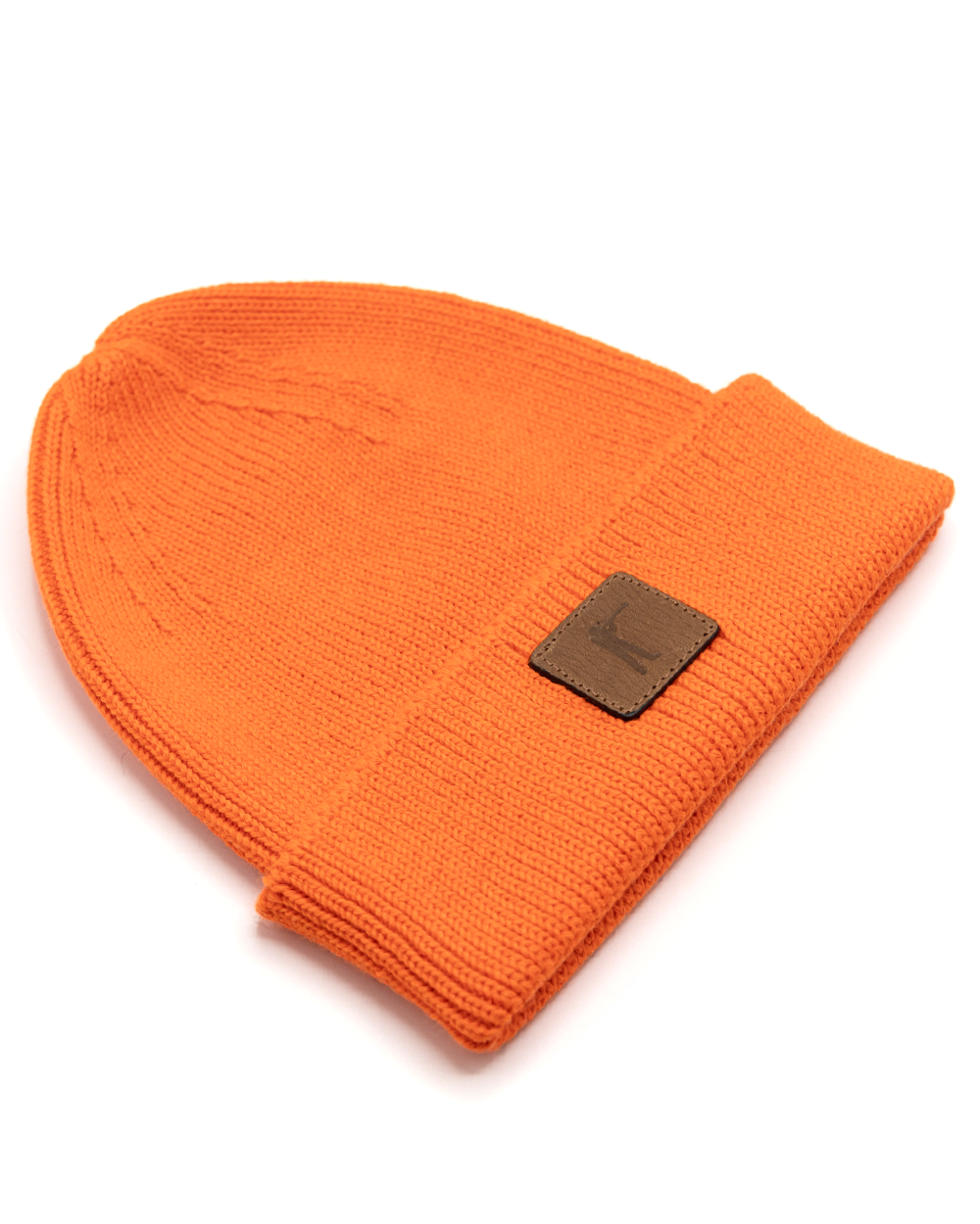 Blaze orange Arthur Knit Hat shown from the side with folded cuff and leather patch