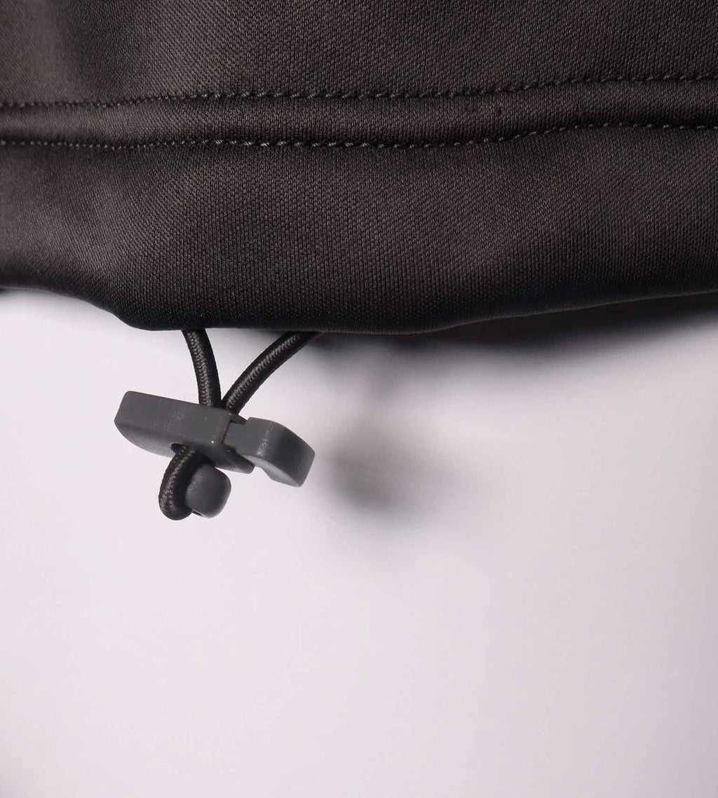 Close-up of the adjustable waist drawstring toggle at the hem of the Vycah Kinsley Vest