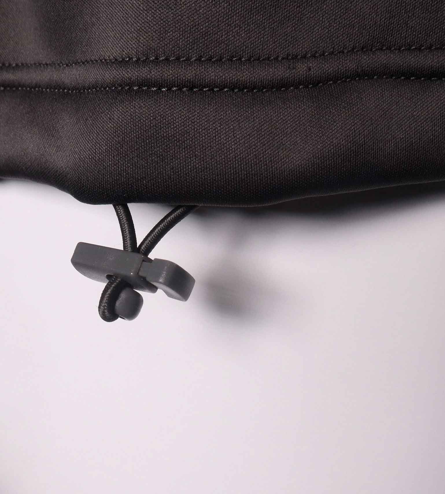 Close-up of the adjustable waist drawstring toggle at the hem of the Vycah Kinsley Vest
