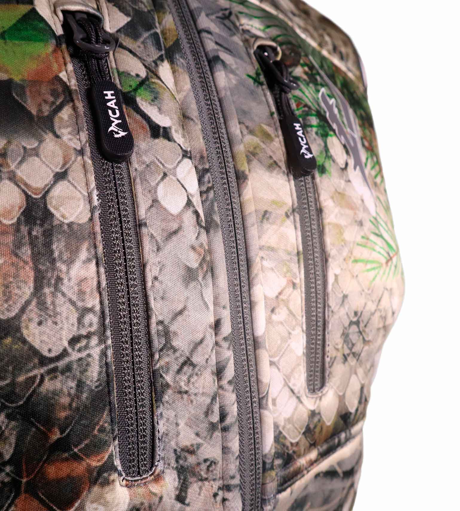 Close-up of the double-zip chest pockets and Vycah zipper pulls on the Kinsley Vest in Fall camo