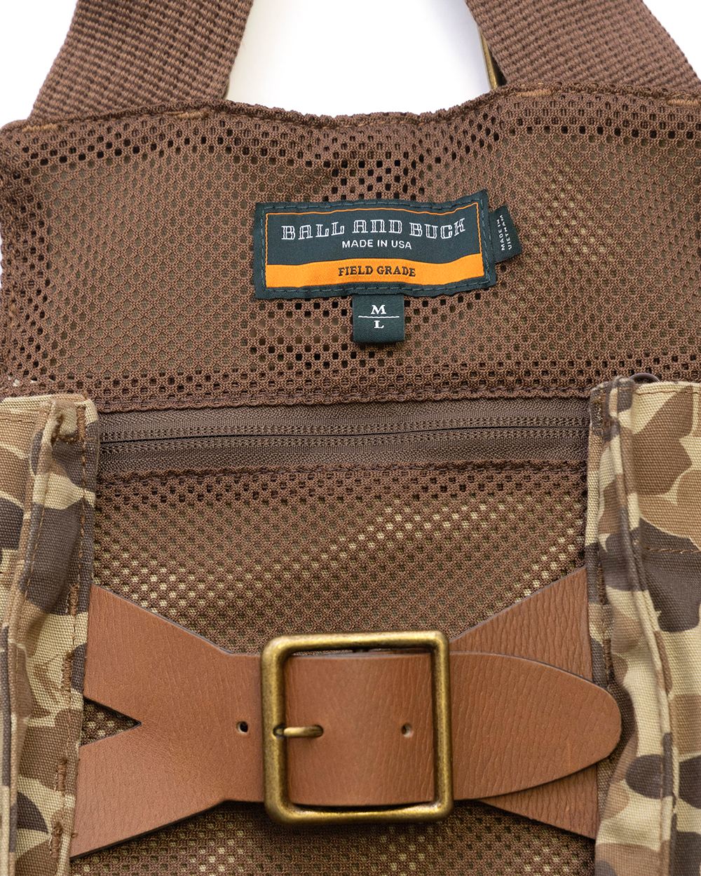 Interior mesh pocket and leather belt closure on the Original Camo Strap Vest