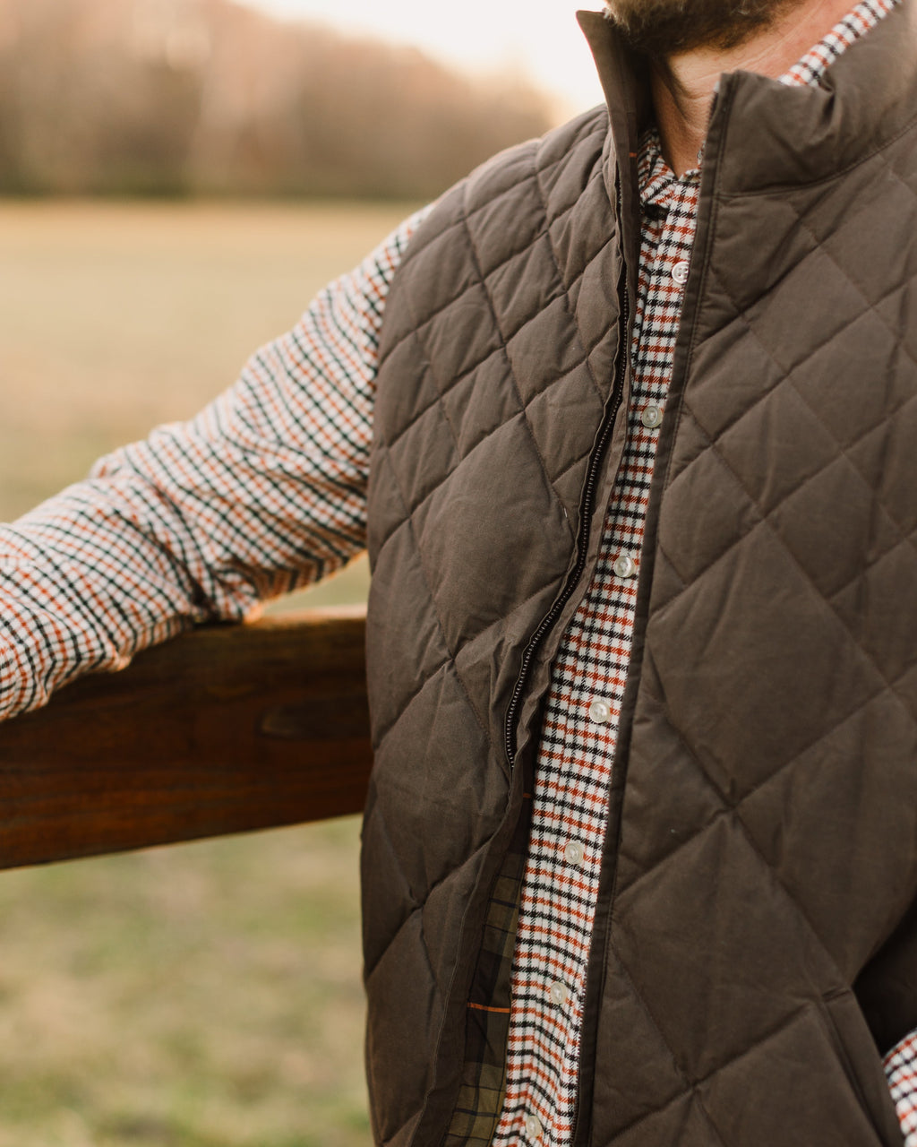 Close-up of the Brown Arthur Down Vest quilting worn at a fence