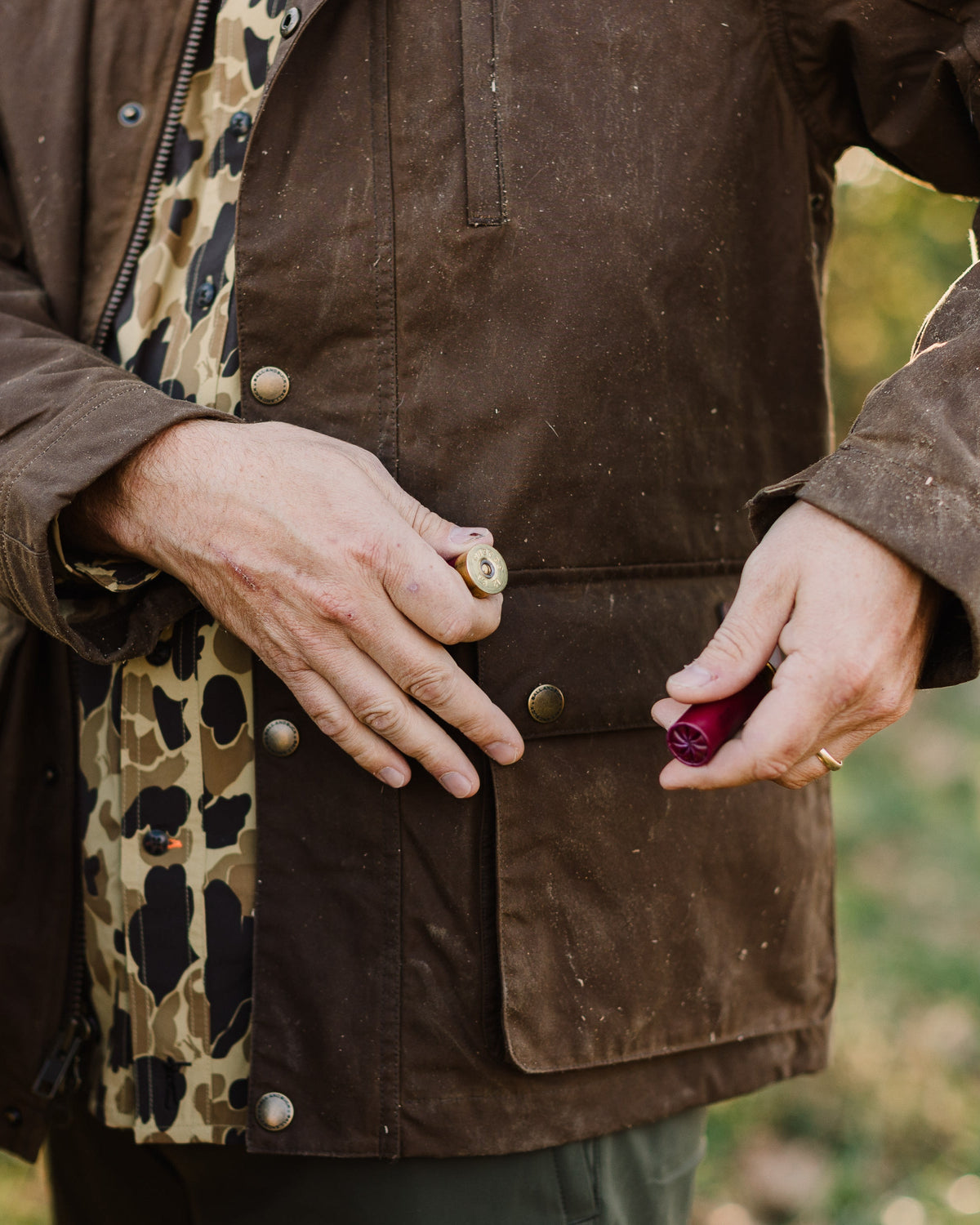 Close-up of the Oak Waxed Field Jacket front with the camo lining showing